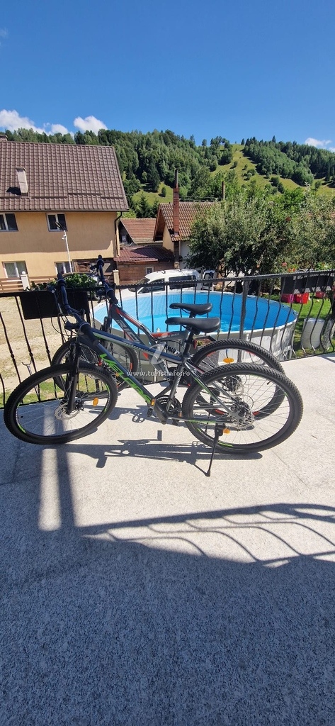 Piscină în curte cu priveliște spre dealuri și biciclete pe balcon